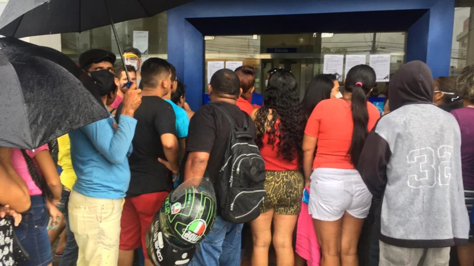 Populares enfrentam risco do coronavírus, filas e chuva em busca de atendimento na Caixa Econômica