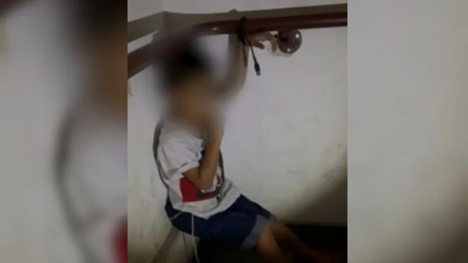 VEJA VÍDEO: mãe amarra filho de 3 anos com cabo de celular em escada