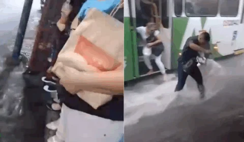 Passageiros de ônibus  fogem de alagamento no Centro de Manaus