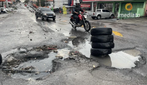 Moradores improvisam sinalização para alertar sobre buracos na Avenida Borba, no bairro Cachoeirinha