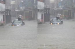 Motorista sobe no teto do carro ao ficar ilhado em alagamento durante forte chuva na zona sul de Manaus